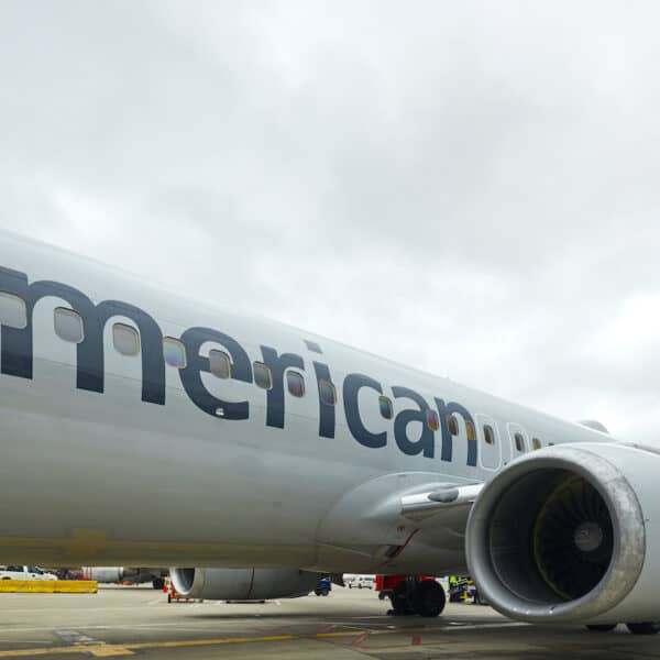 Gray plane on airport tarmac with the word American on left side