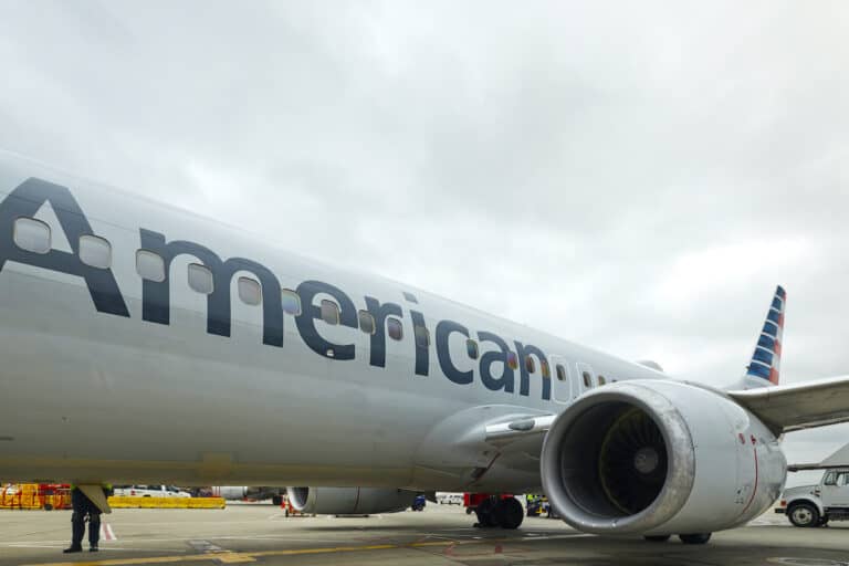 Gray plane on airport tarmac with the word American on left side