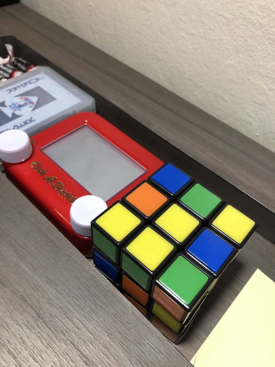 chocolate candy, deck of playing cards, small etch a sketch, and rubik's cube