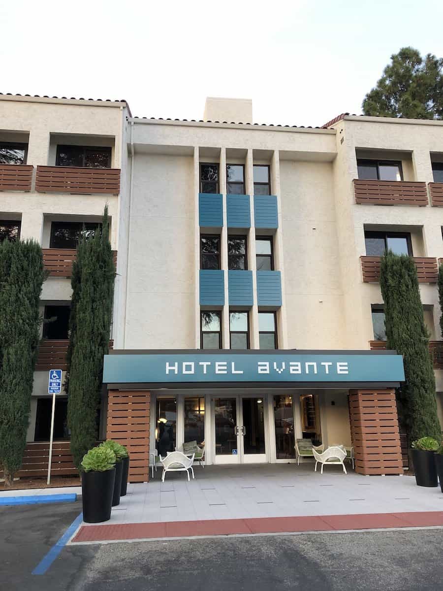 Beige colored hotel with brown wood slat balconies