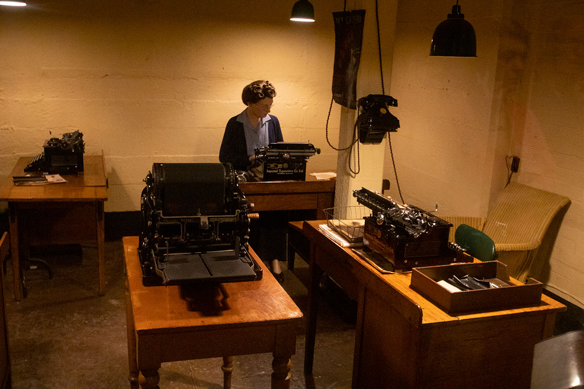 wax figure secretary at typewriter and multiple typewriters in Churchill War Rooms