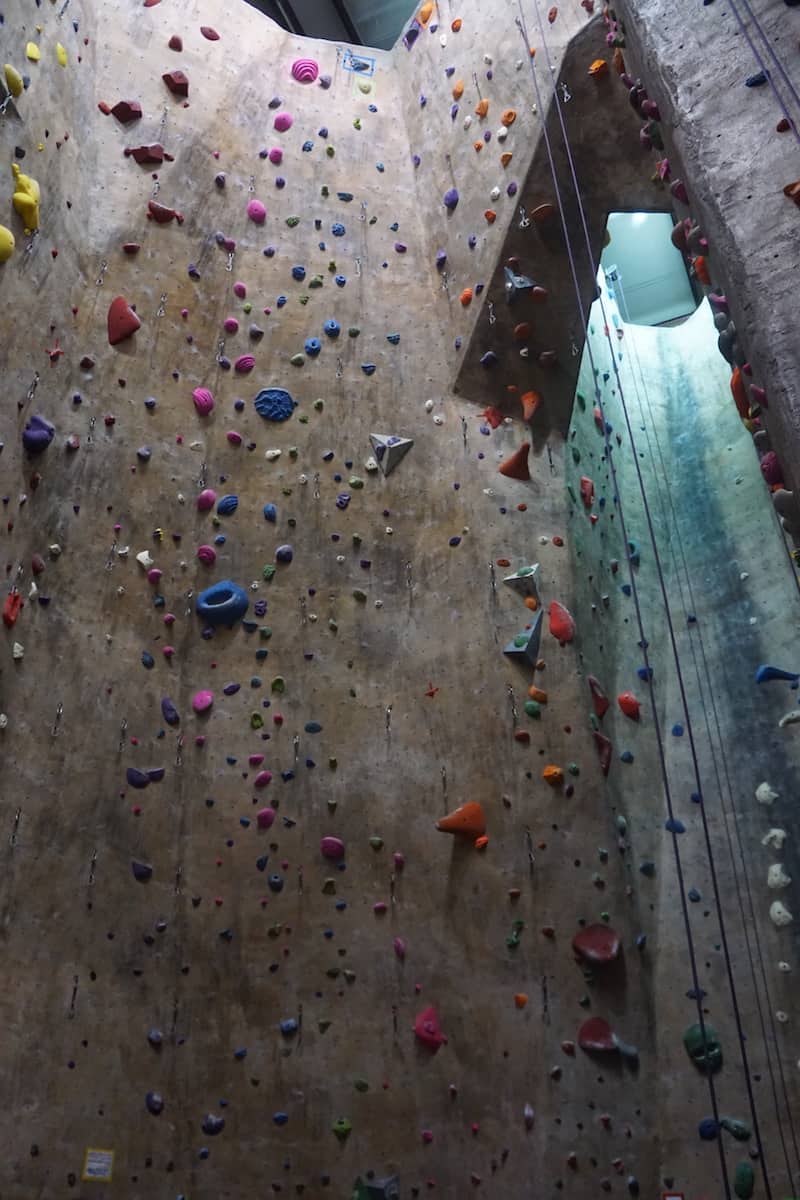 40 foot indoor rock climbing wall with hundreds of colorful hand and foot holds of various sizes