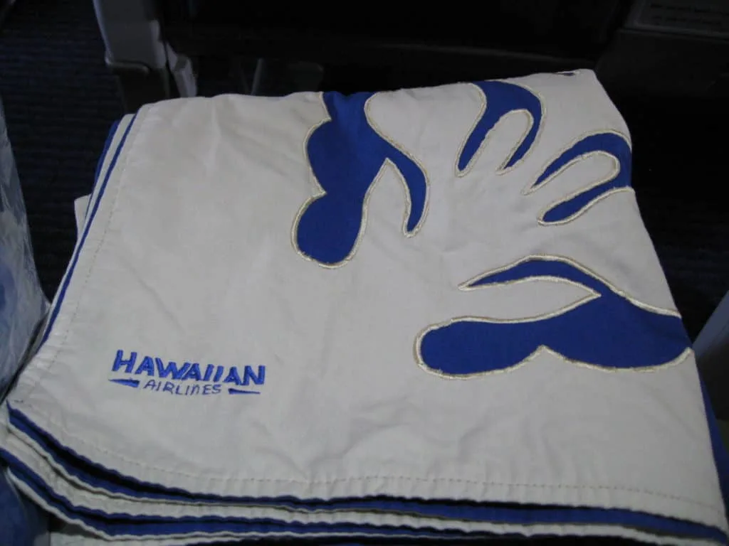 After take-off we were given a Hawaiian patterned blanket and pillow. Traveling Well For Less